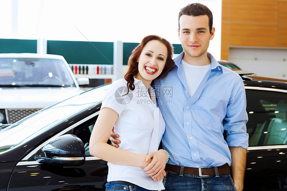在汽车沙龙的年轻幸福情侣男性女士顾客男人钥匙运输女性白色零售夫妻图片