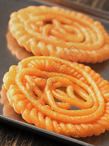印度 Jalebi 甜食食物小吃糖果橙子藏红花螺旋甜点油炸垃圾图片