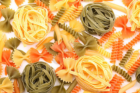 三种颜色的不同面条营养品绿色橙子饺子派对黄色三色螺旋食物图片