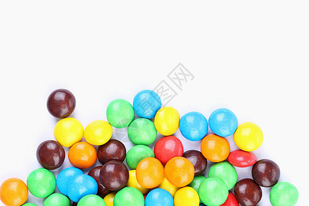 巧克力球在多彩的玻璃上是底色白色糖果多样性红色甜点黄色橙子食物按钮诱惑图片