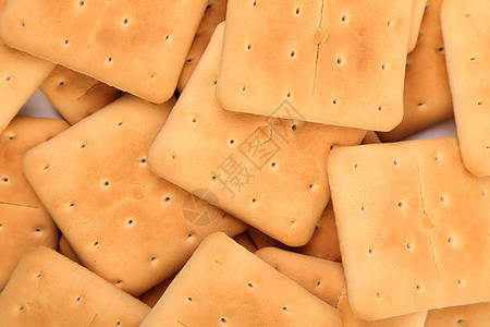 盐碱苏打饼干的背景小吃食物美食棕色正方形长方形饼干饮食黄色早餐图片