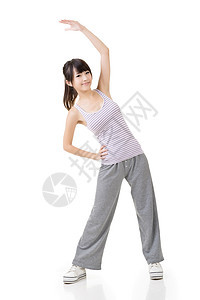 体格适合的年幼女孩进行伸展锻炼活力姿势白色火车运动微笑身体运动装健身房快乐图片