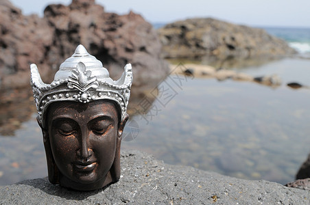 佛像雕像海岸热带塑像沉思岩石上帝金子雕塑海滩太阳图片