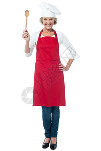 怀着木勺子的快乐老厨师餐饮老太太微笑钢包商业用具转矩女士女性厨房图片