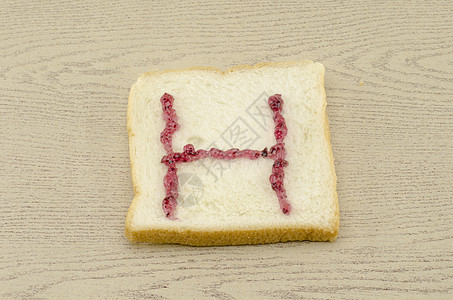 切片面包上的果酱字母表粮食美食谷物早餐小吃面包师食物烹饪营养午餐图片