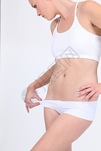 穿着白内裤的妇女橘皮女孩组织运动衣服女士减肥腹部胸部数字图片