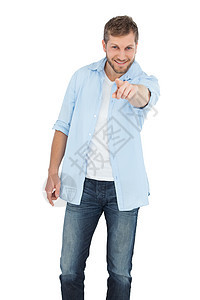 微笑的年轻模特指着镜头衬衫快乐男人牛仔裤牛仔布男性图片