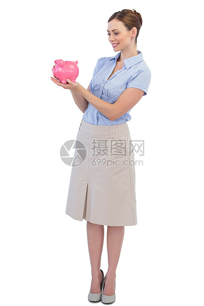 拥有小猪银行的快乐女商务人士图片