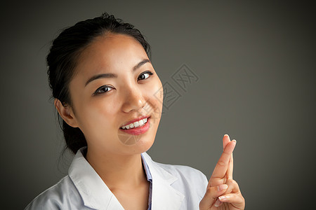 有吸引力的亚洲女孩 20岁在演播室拍摄职业白大褂医生成功快乐医护人员保健科学家喜悦灰色图片