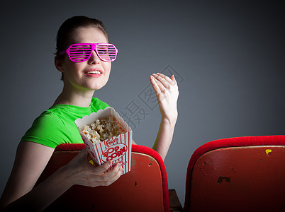 演播室30次拍摄的有吸引力的caucasian女孩微笑喘气电影眼镜冒充休闲服灰色红色背景歌剧图片