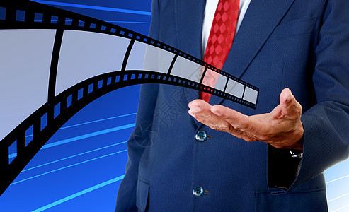 电影工业公司商务人士手中的电影带条商业插图娱乐投资者人士套装相机技术胶卷图片