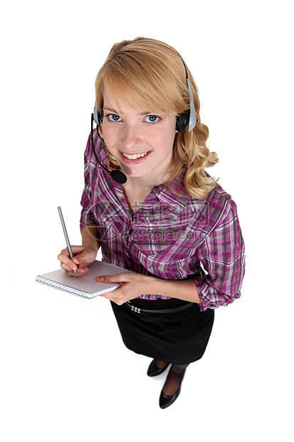 一个戴着耳机的金发女人技术快乐女性女士人士秘书办公室微笑女孩技术员图片