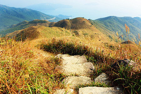 在山上徒步旅行场地天空稻草远足石头岩石芦苇小路高地石径图片