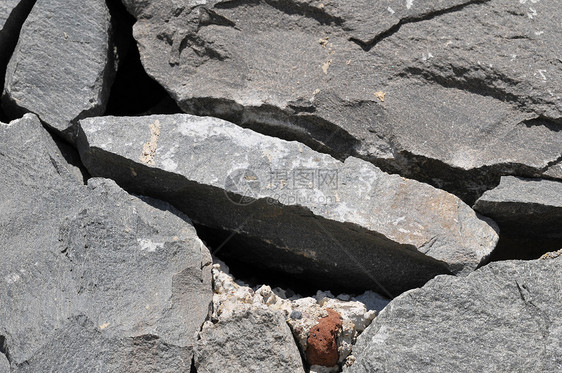 灰岩古城墙宏观石头大理石鹅卵石建筑学黑色石墙矿物风化纹理图片