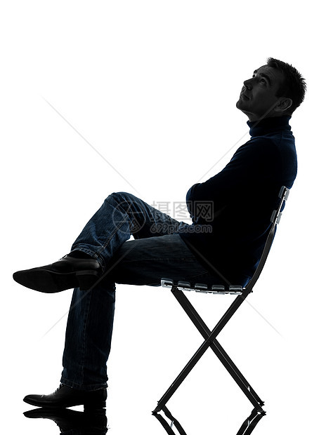 男人坐着看着长长的光影阴影白色座位成人男性休闲装椅子成年人图片