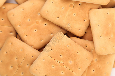盐碱苏打饼干的背景正方形食物饮食小麦黄色宏观美食长方形棕色饼干图片