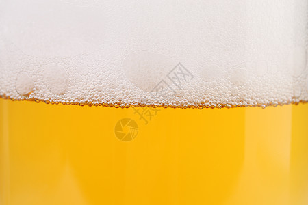 特写啤酒和泡沫气泡饮料泡沫状酒吧白色干杯玻璃黄色棕色发泡图片
