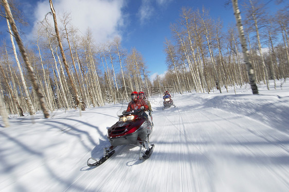 两对夫妇骑着两辆雪轨上的雪车图片