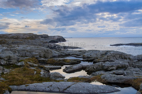 海岸之夜多云蓝色池塘石头海景天气风化岩石日落图片