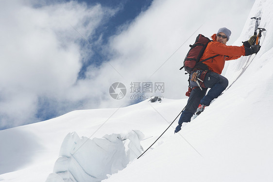 一只男性登山者的侧面景象 它向雪坡上爬去 用斧子挡云绳索娱乐安全远足者冒险家勘探天空远足登山地形图片