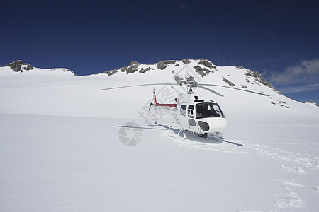 直升机降落在雪山顶上航班航空公司运输情况服务刀刃旅行地形救援风景图片