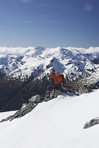 男性登山者的侧边视图 拍摄山峰上雪山的景象假期勘探远足者冒险成人远足天空男人背包孤独图片