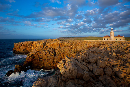 梅诺卡岛灯塔巴利阿里群岛灯塔海洋日落假期石头海岸线天空岩石旅行波浪图片
