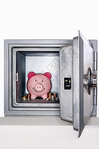 开着保险箱的猪头银行和硬币背景图片