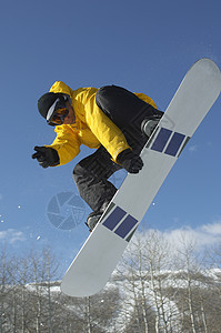 冬季衣着跳雪的男性滑雪者在对天空显示胜利标志时 低角度观察图片