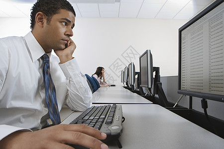 商务人士在计算机实验室使用个人电脑的侧面视图 妇女坐在背景上图片