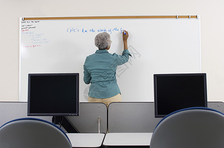 在电脑课的白板上写作 一位资深老师的近视图片