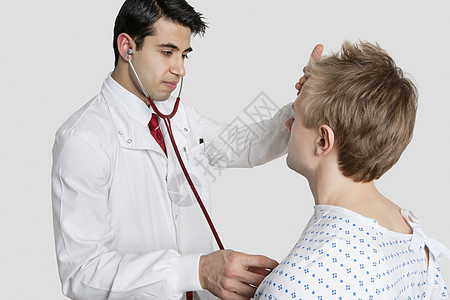 印度医生用听诊器检查男性病人的诊断图片