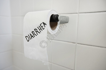 卫生间内写有腹泻的厕所纸卷贴上背景图片