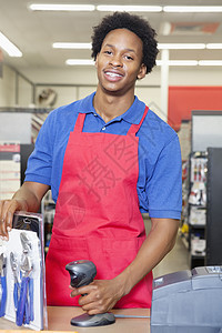 一名非裔美国人男商店店员站在退票柜台的肖像图片