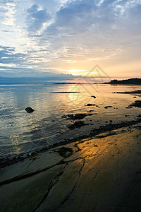 海上日落橙子反射天空假期地平线海滩太阳阳光海浪海岸图片