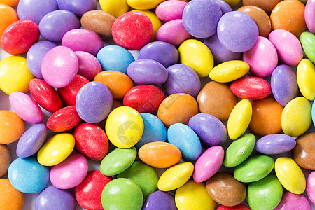 彩色糖果堆叠团体宏观食物白色棕色绿色小吃橙子粉色巧克力图片