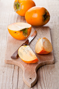 成熟的百西门和刀水果食物木板木头宏观美食营养橙子甜点桌子图片