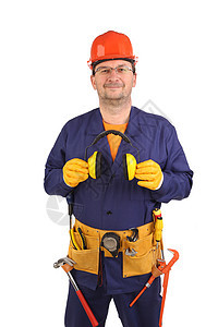 戴着耳罩和眼镜的自信工人劳动工具建筑扳手工人橙子管道蓝色耳朵工作图片
