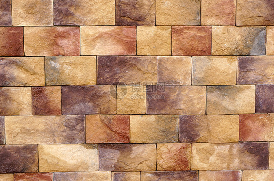 不同有色石头块的墙壁纹理材料棕色石头水泥地面风化砖块图片