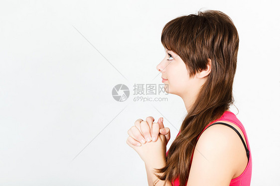 可爱的年轻女孩向上祈祷图片
