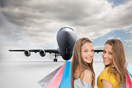 两名携带购物袋的青年妇女的综合形象图象飞机地面女性女士航空衣服青少年金发金发女郎旅游图片