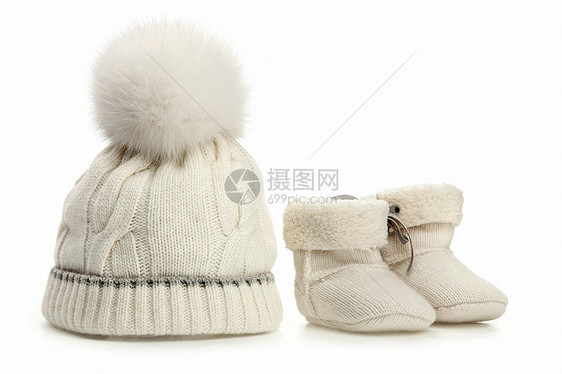 温暖的羊毛婴儿帽和靴子在白色之上图片