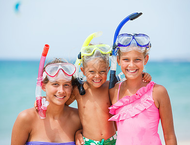 海滩上三个快乐的孩子说谎运动孩子们活动幸福兄弟海洋浮潜海滨乐趣图片