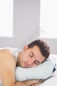 沉睡的帅帅帅男人在床上放松图片