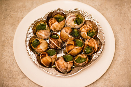 贴近有大蒜黄油的埃斯加高地美食服务烹饪食物螺旋蜗牛文化饮食香菜餐厅图片
