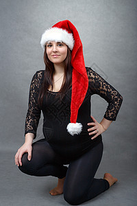 怀着小肚子的漂亮怀孕的圣塔孕妇腹部红色婴儿女士母性女性成人生活父母白色图片