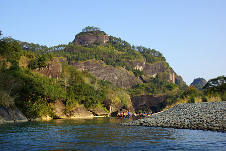 中国福建省武伊山峡谷 中国阳光岩石流动旅行吸引力溪流风景石头高地太阳背景图片