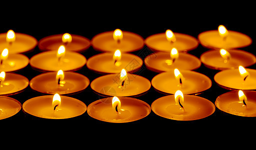 茶灯点火蜡烛黑暗火焰团体灯芯烧伤辉光黑色橙子启发性照明图片