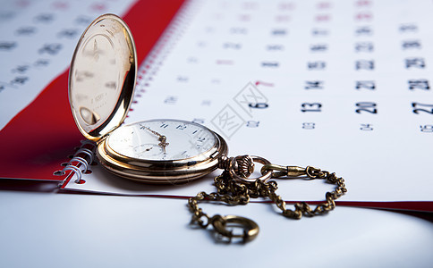 金袖手表和墙上的日历口袋性情金子怀表时间商业数字白色图片