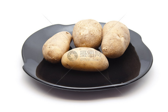陶瓷板上新鲜的棕色土豆花园陶瓷食品场地黑色蔬菜食物饮食图片